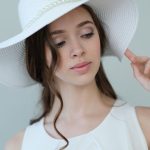 Beauty and fashion. Woman in white hat