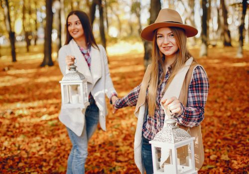 Beautiful girls in a park. Cute ladies in a stylish clothes
