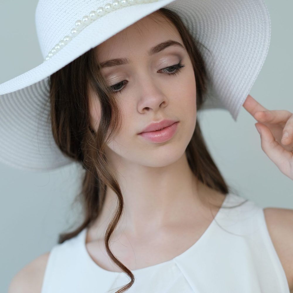 Beauty and fashion. Woman in white hat